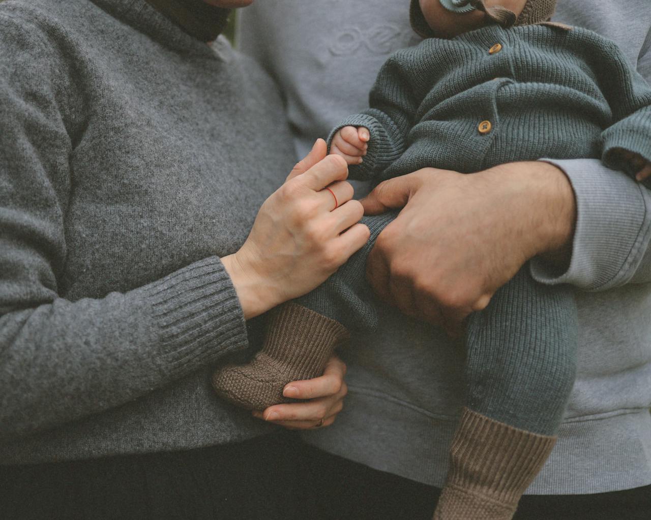 Crafting Captivating Headlines: Your awesome post title goes here Close-up of parents gently holding their baby, showcasing family love.
